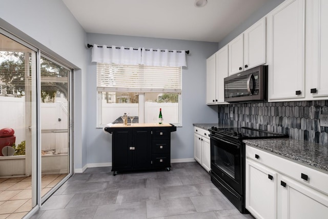 kitchen with white cabinets, backsplash, black range with electric cooktop, and dark stone counters