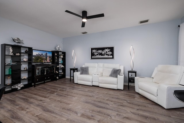 living room with hardwood / wood-style flooring and ceiling fan