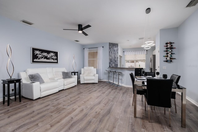 dining room with ceiling fan and light wood-type flooring