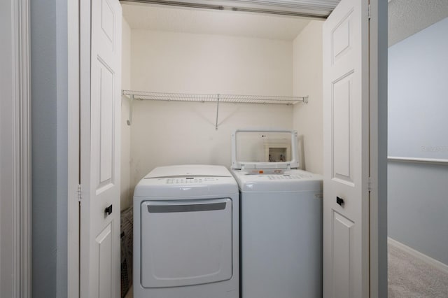 laundry area with independent washer and dryer, carpet floors, and a textured ceiling