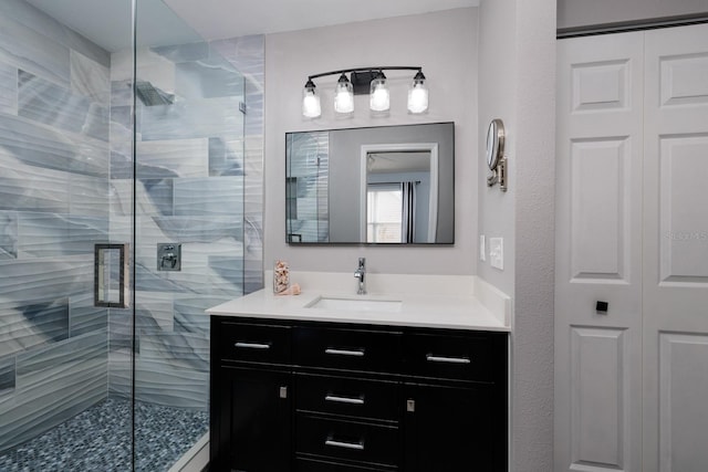 bathroom featuring vanity and a shower with door