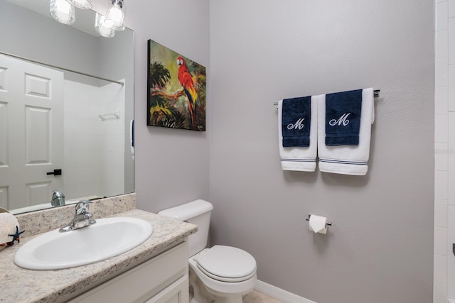 bathroom featuring vanity, toilet, and walk in shower