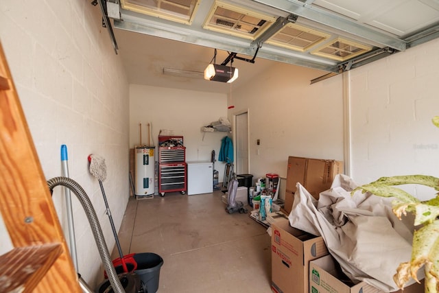 garage with electric water heater and a garage door opener