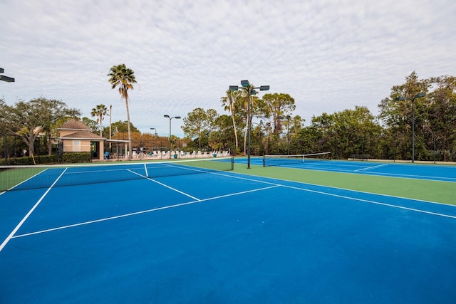 view of tennis court featuring basketball court