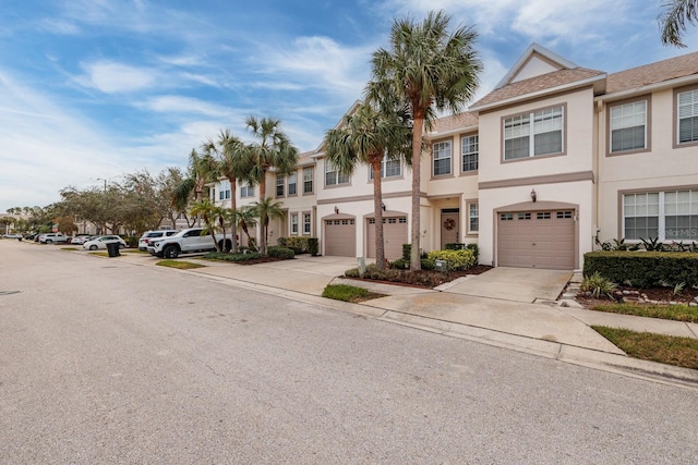 townhome / multi-family property featuring a garage