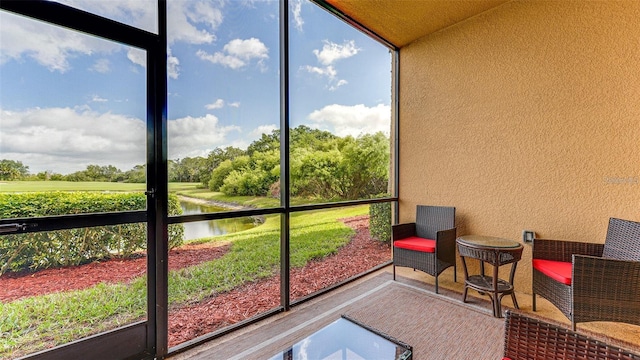 sunroom / solarium with a healthy amount of sunlight and a water view