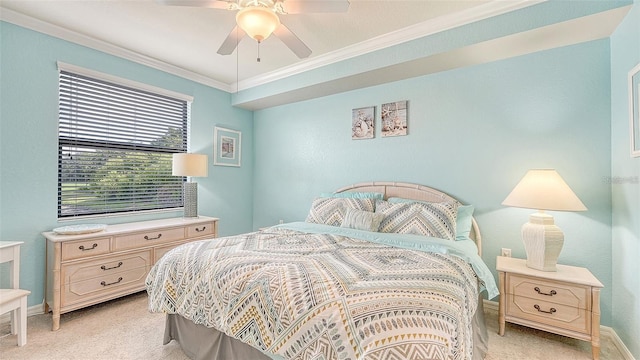 carpeted bedroom featuring ceiling fan and crown molding