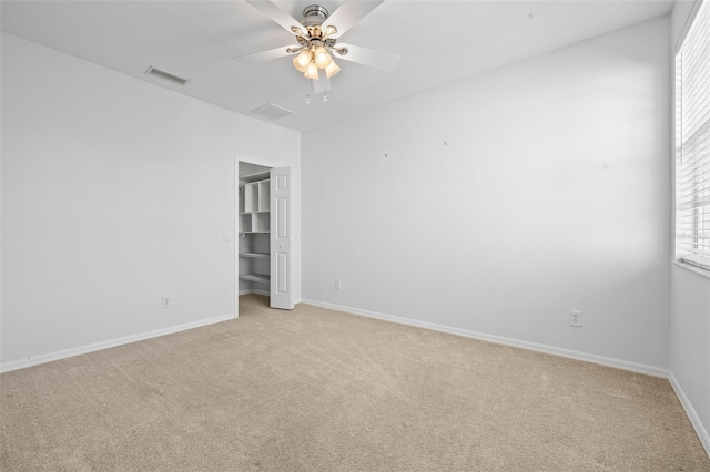 spare room with light carpet and ceiling fan