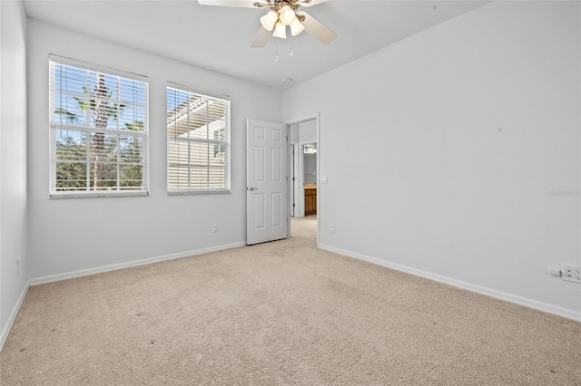 carpeted empty room featuring ceiling fan