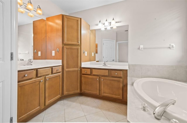 bathroom with tile patterned floors, tiled bath, and vanity