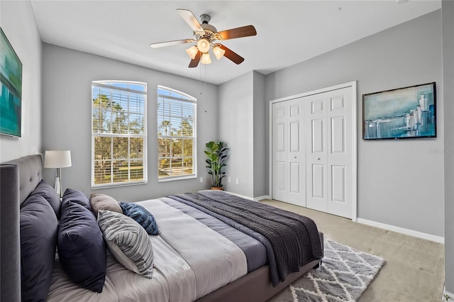 carpeted bedroom with a closet and ceiling fan