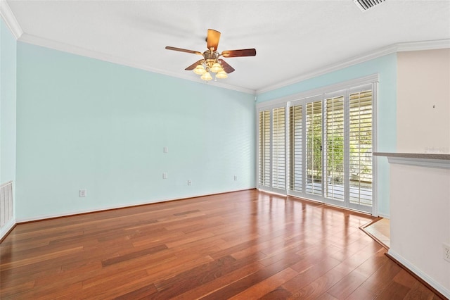 empty room with hardwood / wood-style flooring, ceiling fan, and ornamental molding