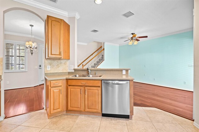 kitchen featuring dishwasher, sink, hanging light fixtures, light tile patterned floors, and ornamental molding