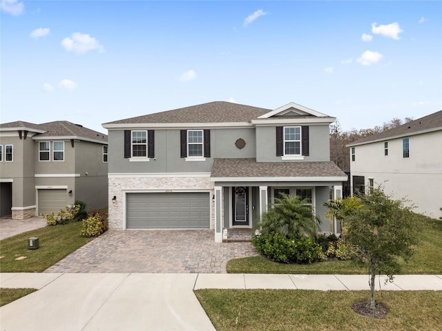 front facade featuring a garage and a front yard