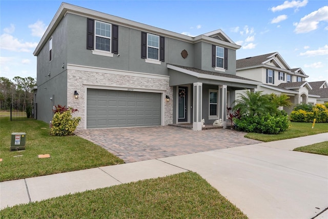 view of front facade featuring a front lawn and a garage