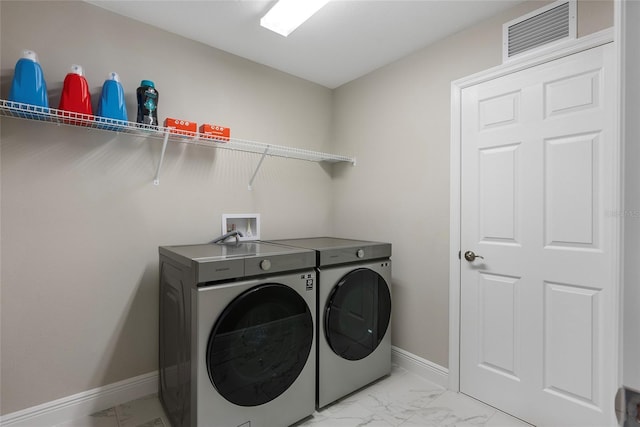 laundry room with washing machine and clothes dryer