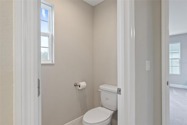 bathroom with toilet and a healthy amount of sunlight