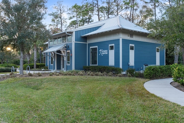 view of side of home with a lawn