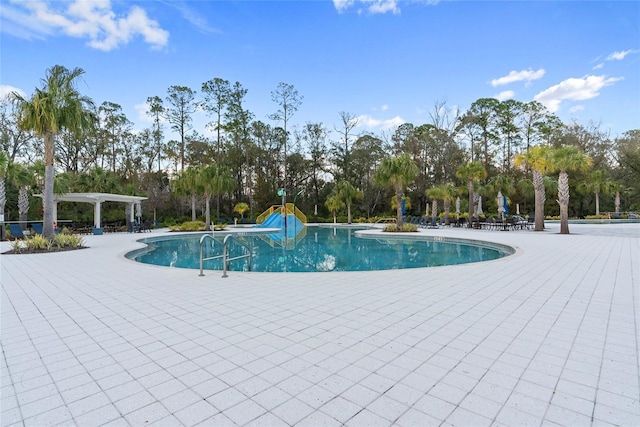 view of swimming pool featuring a pergola