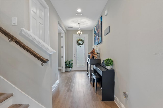 entrance foyer with a chandelier and light wood-type flooring