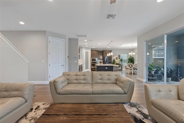 living room featuring hardwood / wood-style floors and a notable chandelier