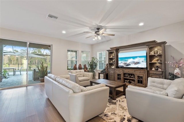 living room with light wood-type flooring and ceiling fan