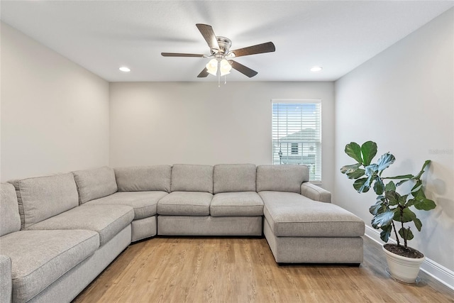 living room featuring ceiling fan and light wood-type flooring