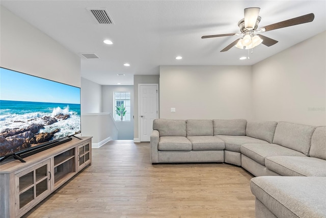 living room with ceiling fan and light hardwood / wood-style floors