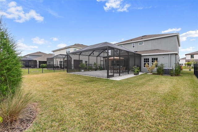 rear view of property featuring a lanai, a patio area, cooling unit, and a yard