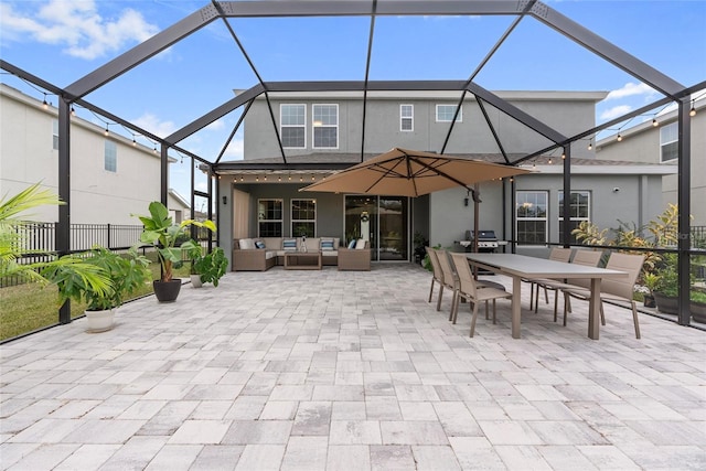 back of property featuring an outdoor living space, a patio area, and glass enclosure