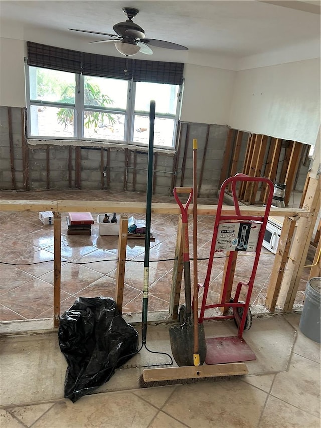 unfurnished room featuring a ceiling fan and a wealth of natural light