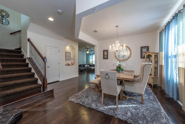 dining area featuring ceiling fan with notable chandelier and dark hardwood / wood-style floors