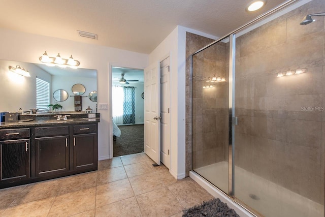 bathroom with ceiling fan, tile patterned flooring, vanity, and an enclosed shower