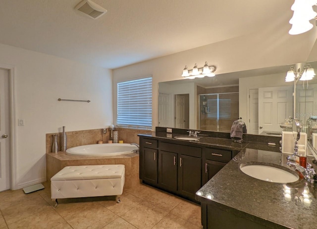 bathroom featuring tile patterned floors, vanity, and plus walk in shower