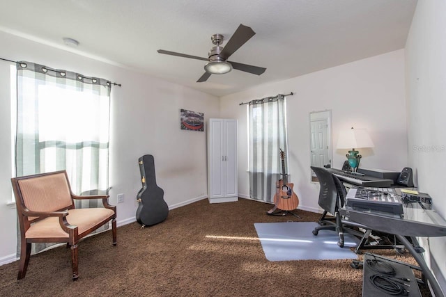 carpeted office space featuring ceiling fan