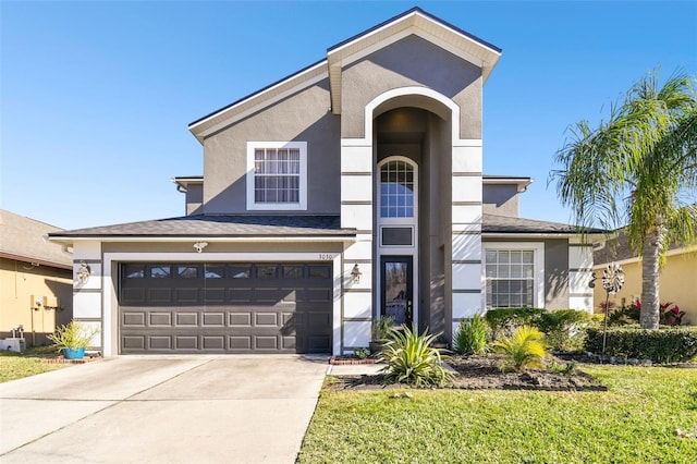 view of front facade featuring a front yard and a garage