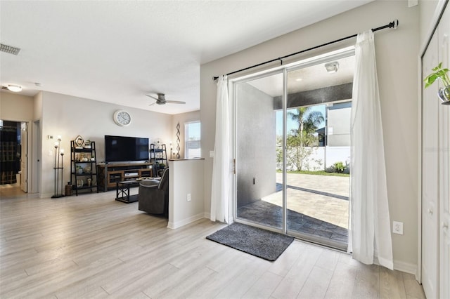 entryway featuring ceiling fan and light hardwood / wood-style floors