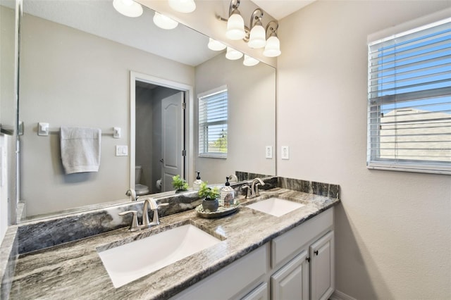 bathroom featuring vanity and toilet