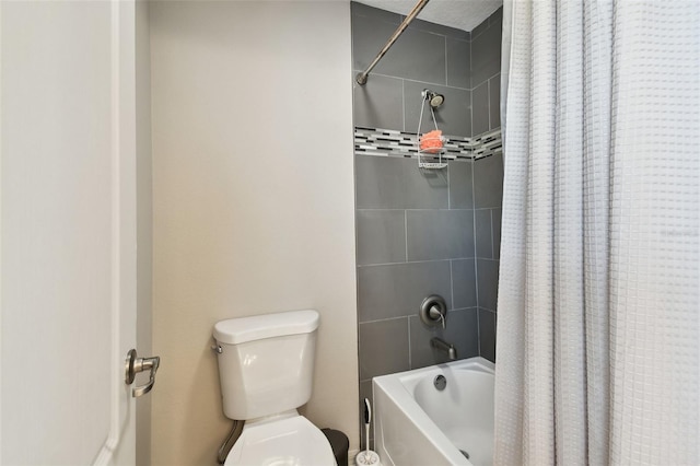 bathroom featuring shower / bath combo and toilet