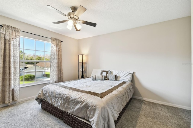 carpeted bedroom with a textured ceiling and ceiling fan