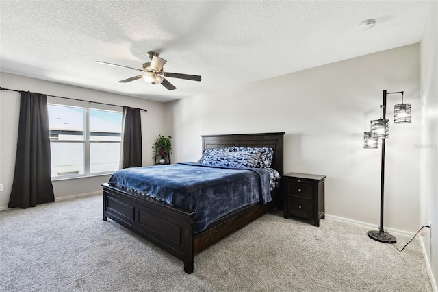 bedroom with light carpet, a textured ceiling, and ceiling fan