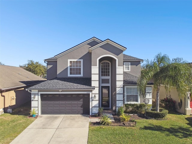 view of front of house with a garage and a front yard