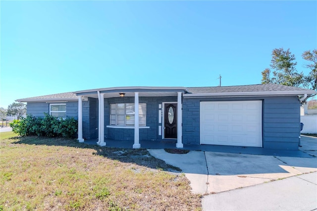 single story home with a garage and a front lawn