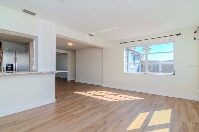 empty room with light hardwood / wood-style floors