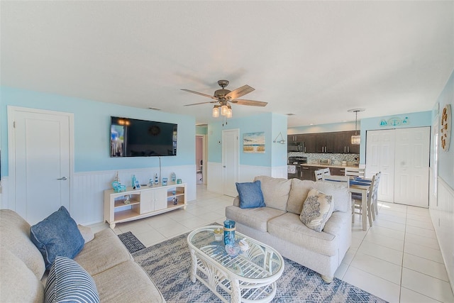 living room featuring ceiling fan and light tile patterned flooring