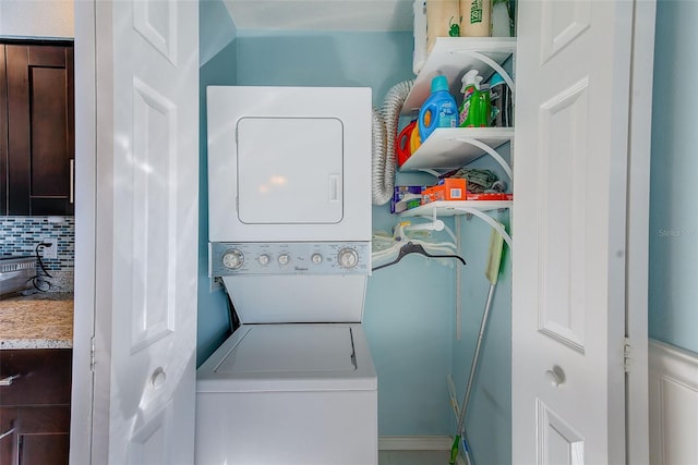 laundry area featuring stacked washer and clothes dryer