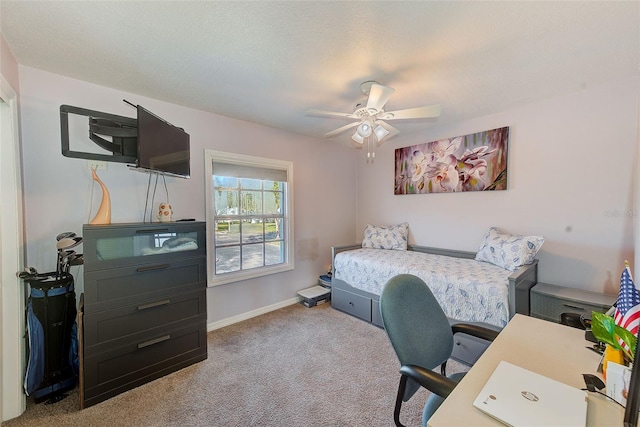 carpeted bedroom with a textured ceiling and ceiling fan