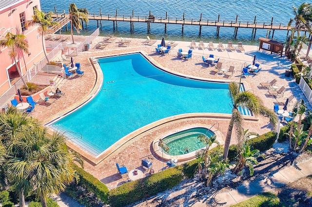 view of swimming pool with a water view