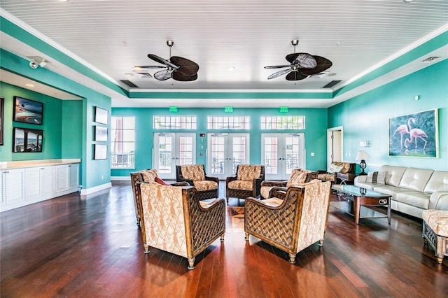 living room featuring french doors, plenty of natural light, and dark wood-type flooring