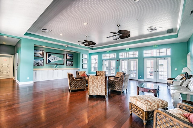 living room with dark hardwood / wood-style flooring, wood ceiling, a tray ceiling, and french doors